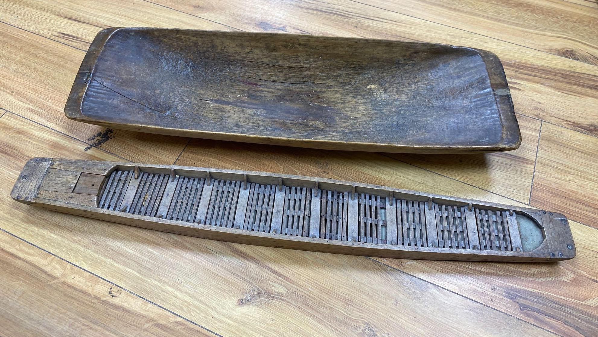 A 19th century primitive beech rectangular dish, carved from the solid, 64cm, a Victorian cast iron pedestal stand, 28cm and a model wo